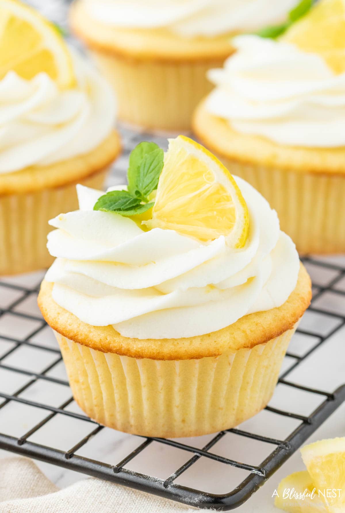 Lemon cupcake on a cooling rack. 