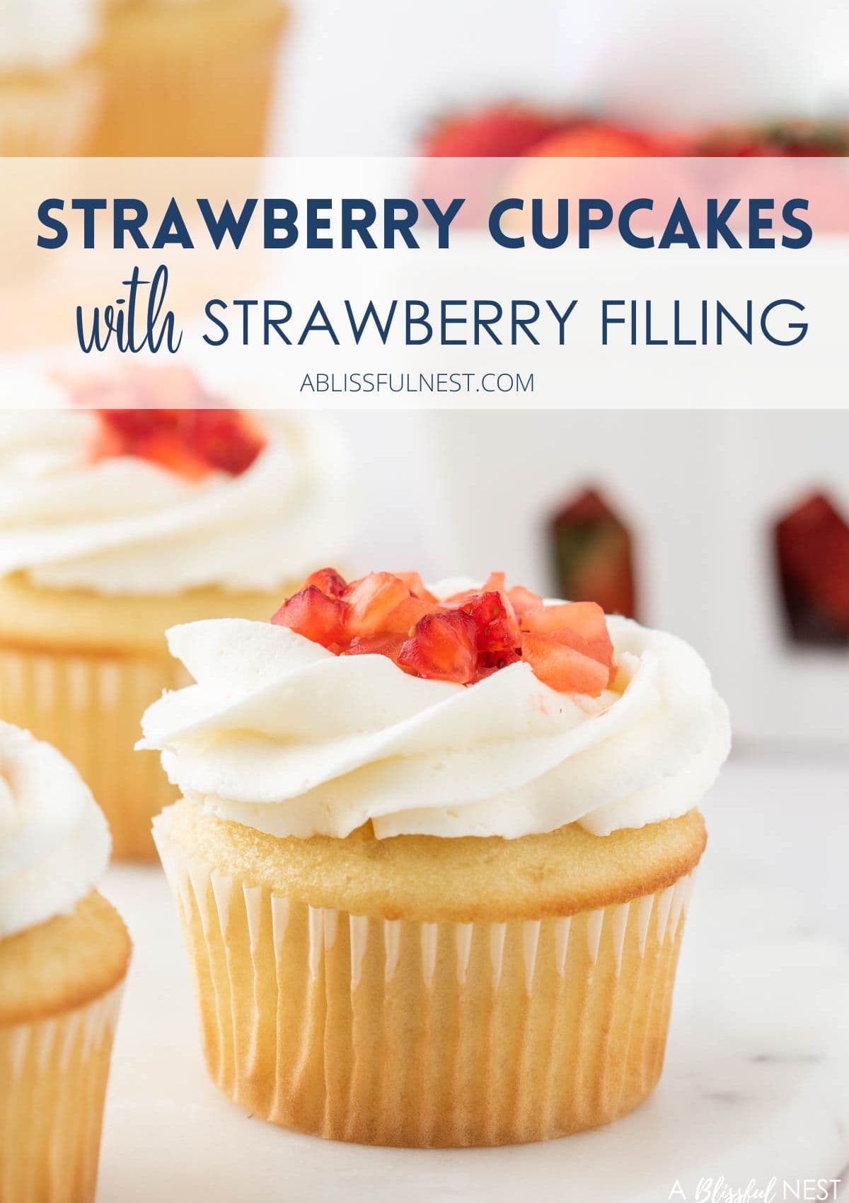 Cupcake with cut strawberries and buttercream frosting.