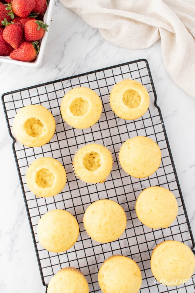 Cupcakes with the middle cut out to fill with cut strawberries.