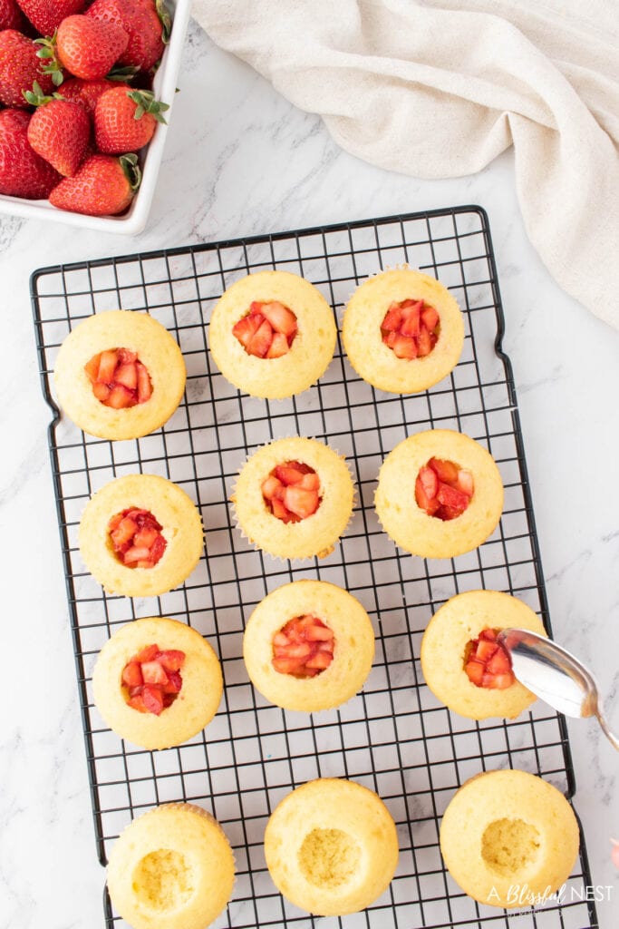 Fill the middle of cupcake with cut strawberries