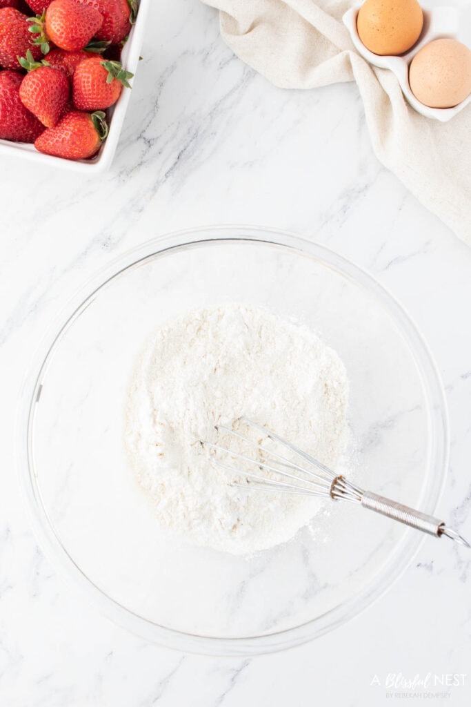 Flour, baking soda, and baking powder in a mixing bowl.