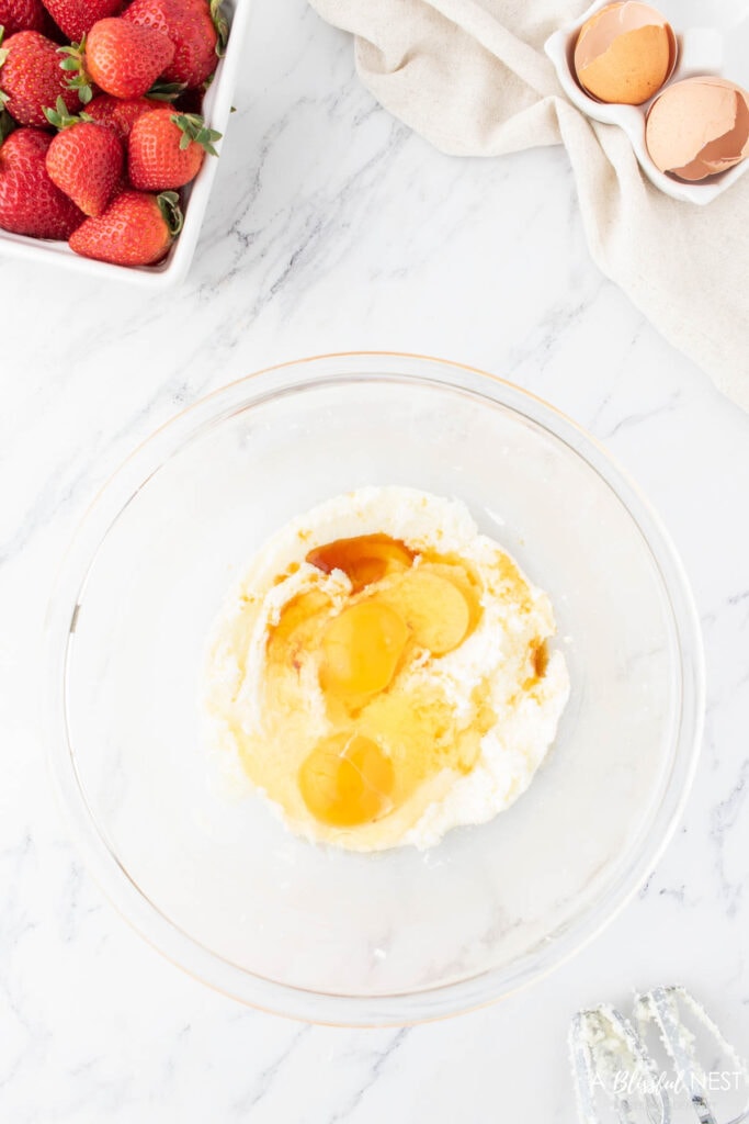 Wet ingredients like eggs and vanilla added to dry ingredients.
