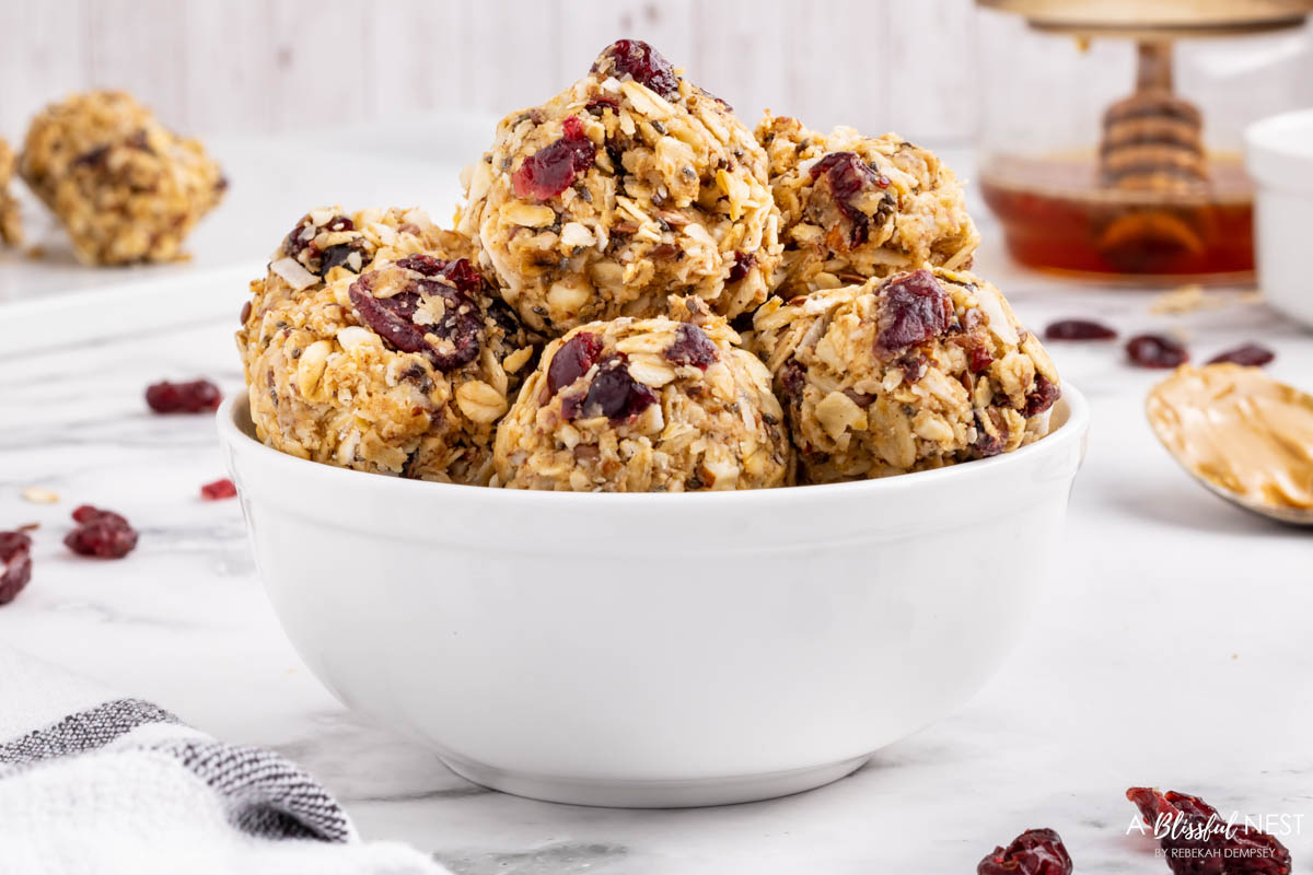 white bowl of energy balls on a counter.