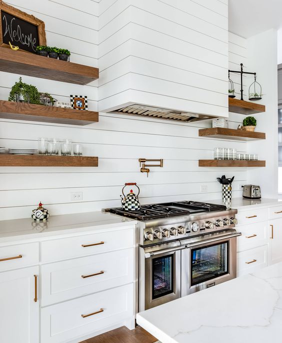 shiplap range hood, white cabinets, shiplap backsplash, floating wood shelves, gold cabinet hardware