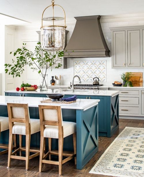 dark teal kitchen islands with white cabinetry, dark grey range hood.