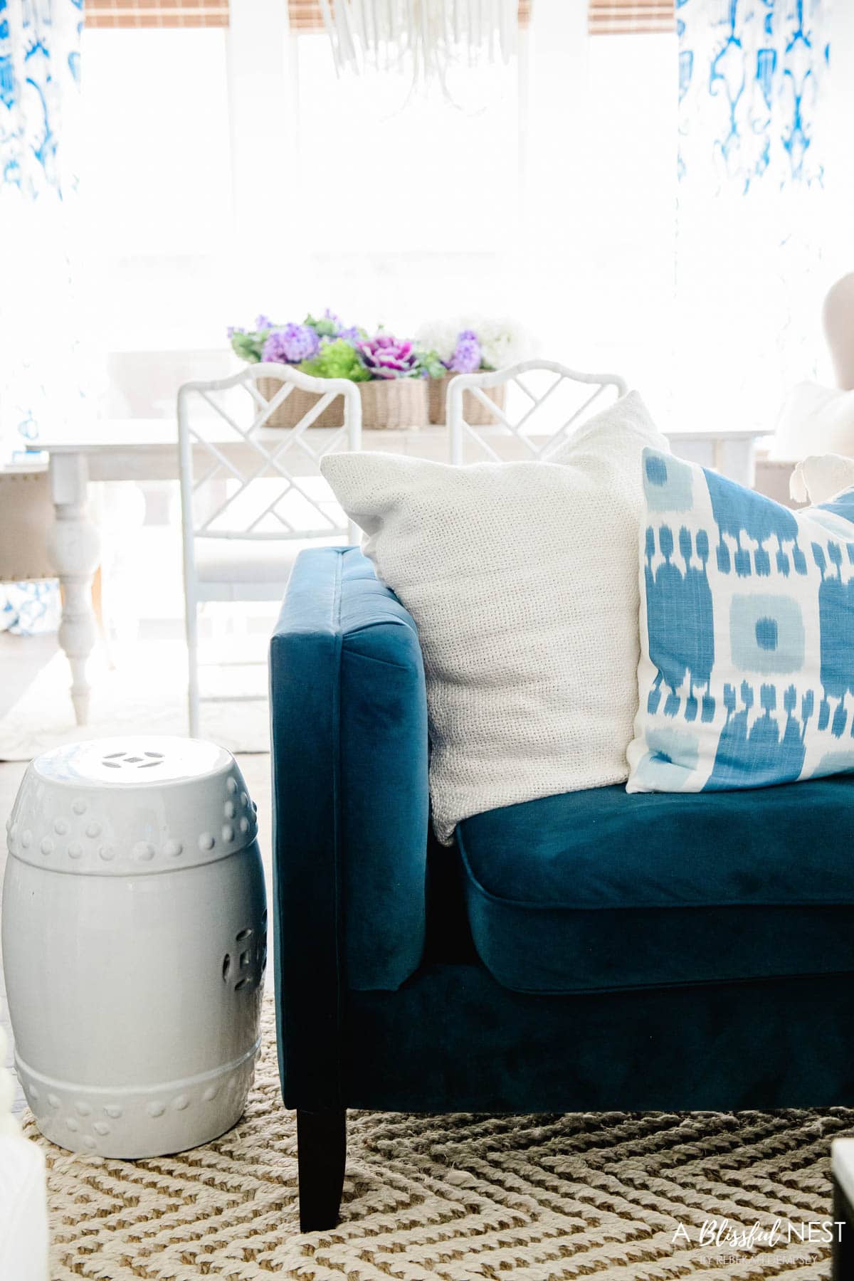 cream linen pillow mixed with blue ikat pillow on navy sofa