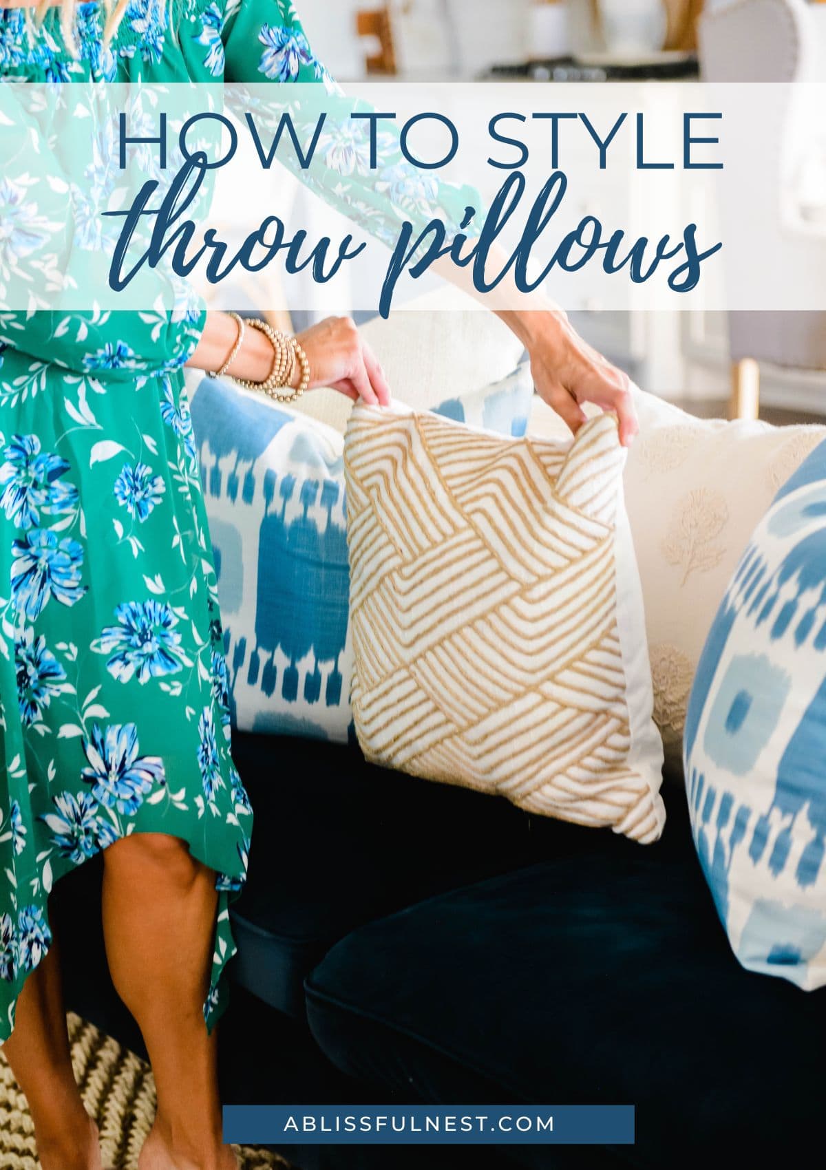 placing a jute pillow on a navy blue sofa