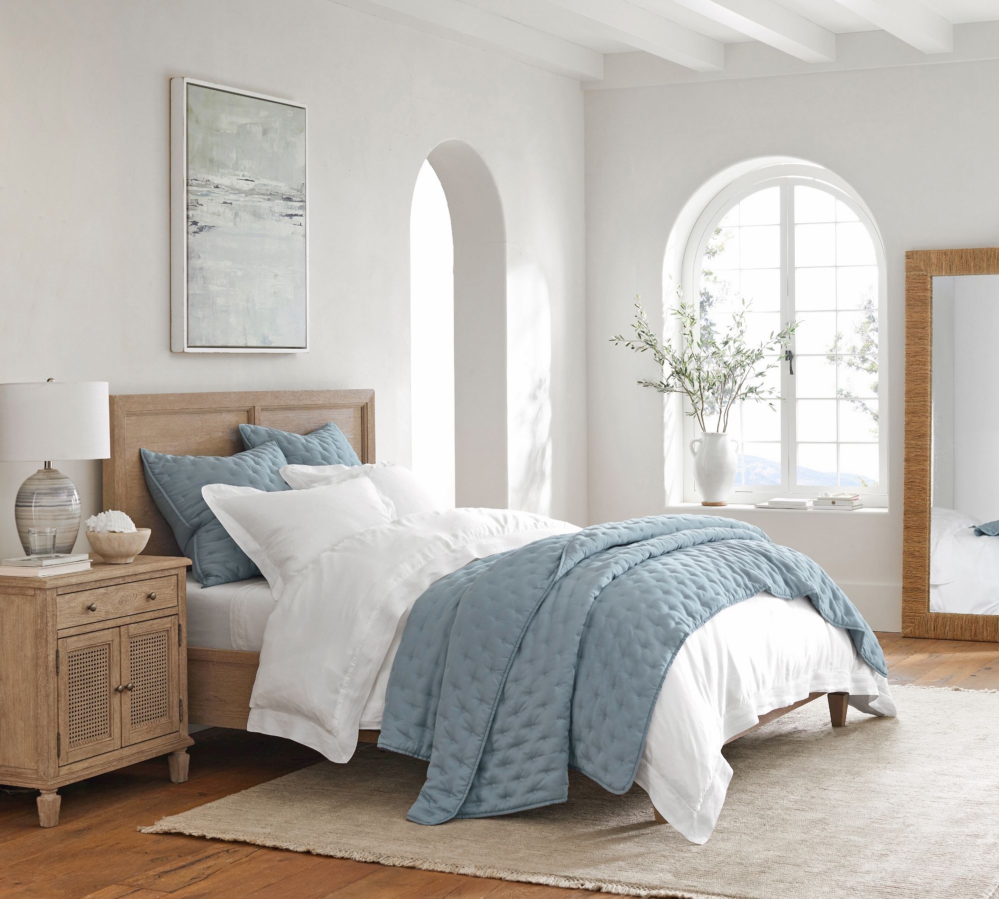 Porcelain blue quilt and pillows mixed with all white bedding