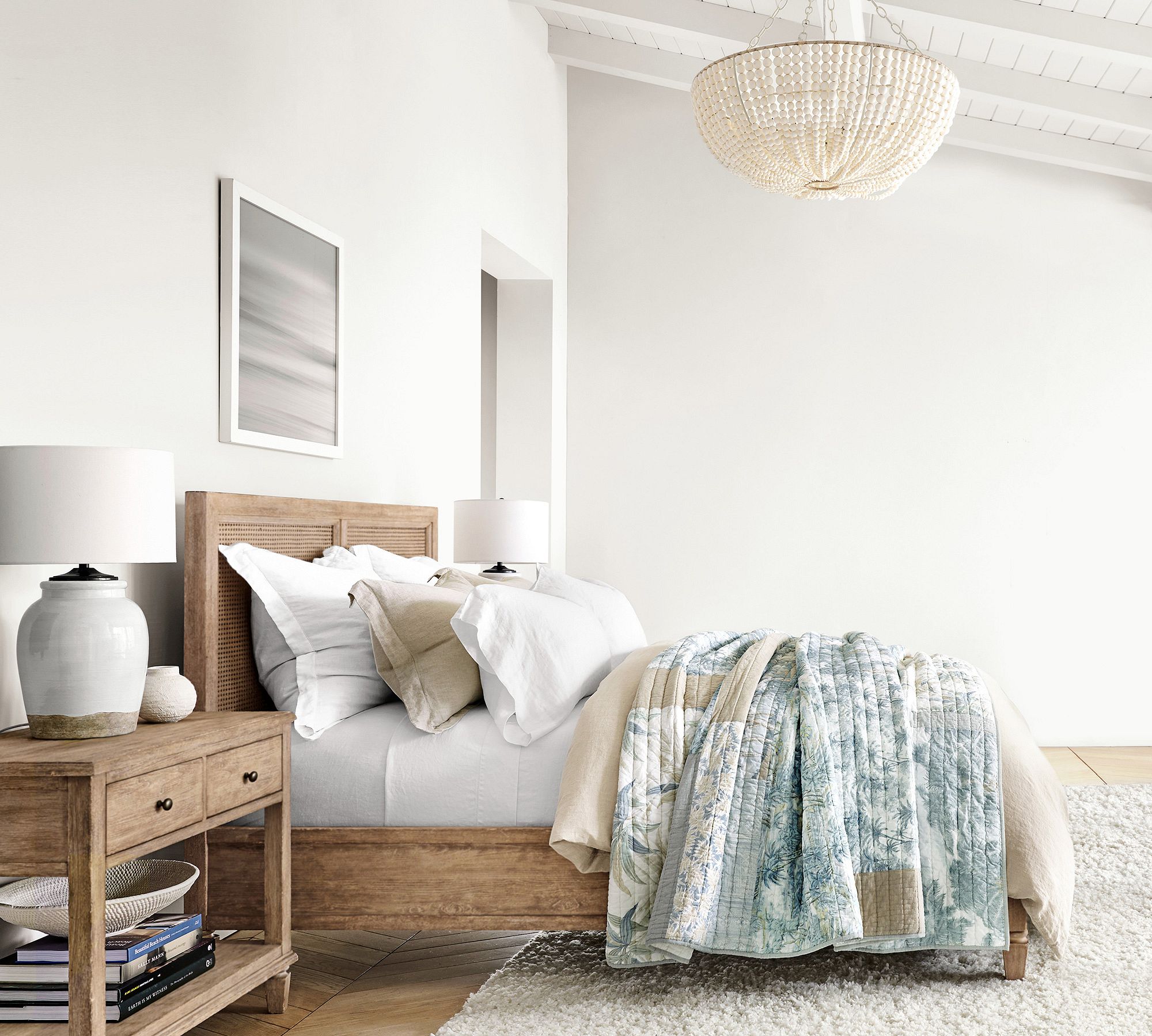 white bedding mixed with blue and tan quilt set. 