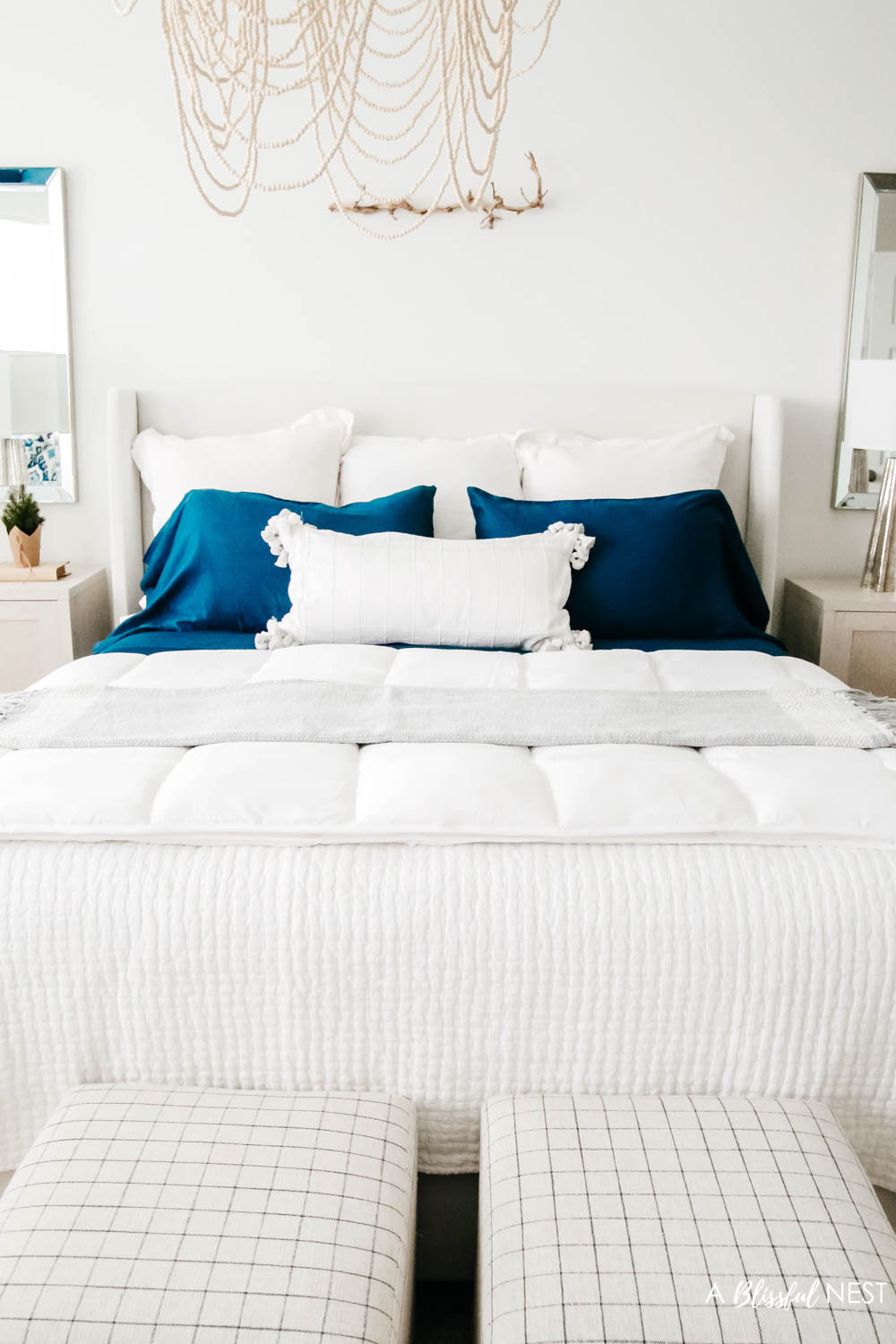 3 white euro shams, 2 navy sleeping pillows and 1 decorative lumbar pillow