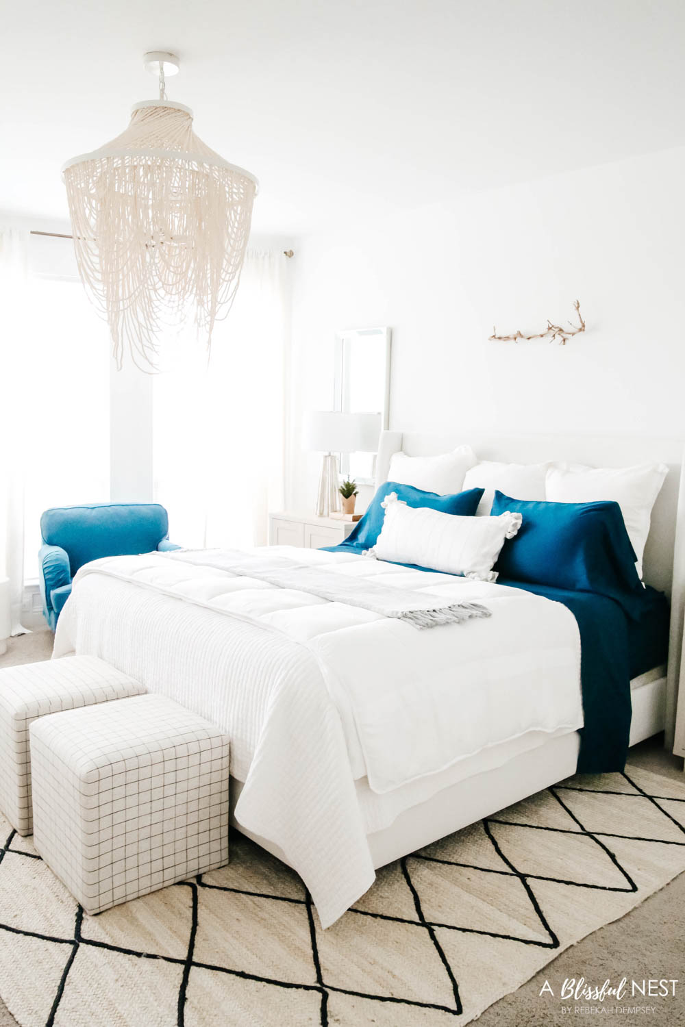 2 blue chairs tie in with the navy sheet set on the bed