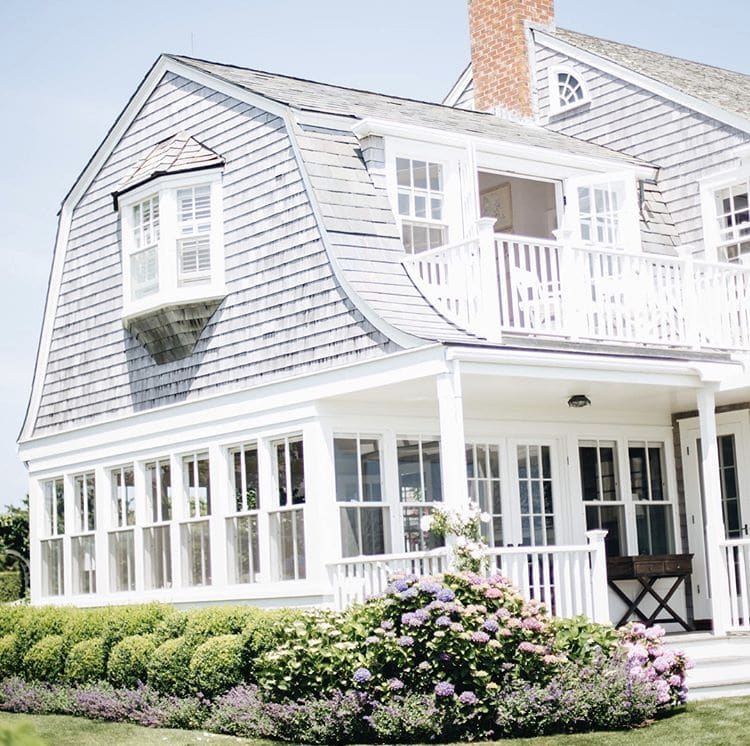 cape code style home with gable roof detail