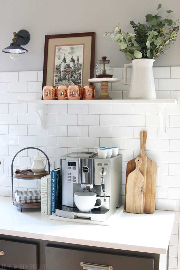espresso machine on a kitchen counter with some cutting boards. 