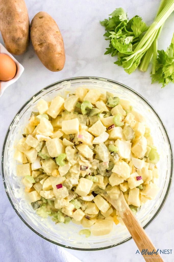 chopped ingredients mixed with cubbed potatoes