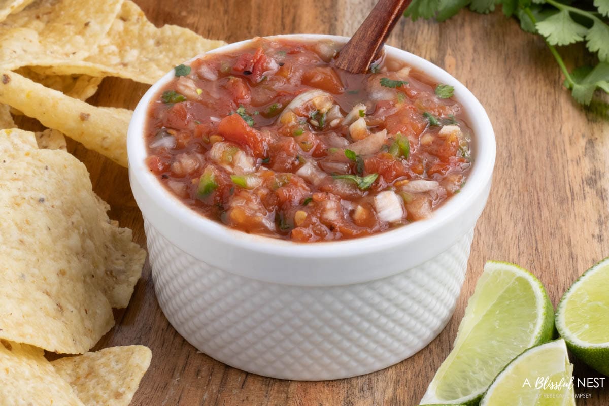 salsa in a white bowl on a cutting board