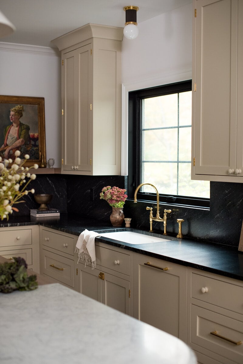 beige kitchen cabinets with black countertops