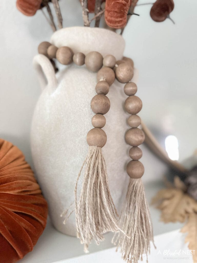 wood bead garland tied to the next of a vase