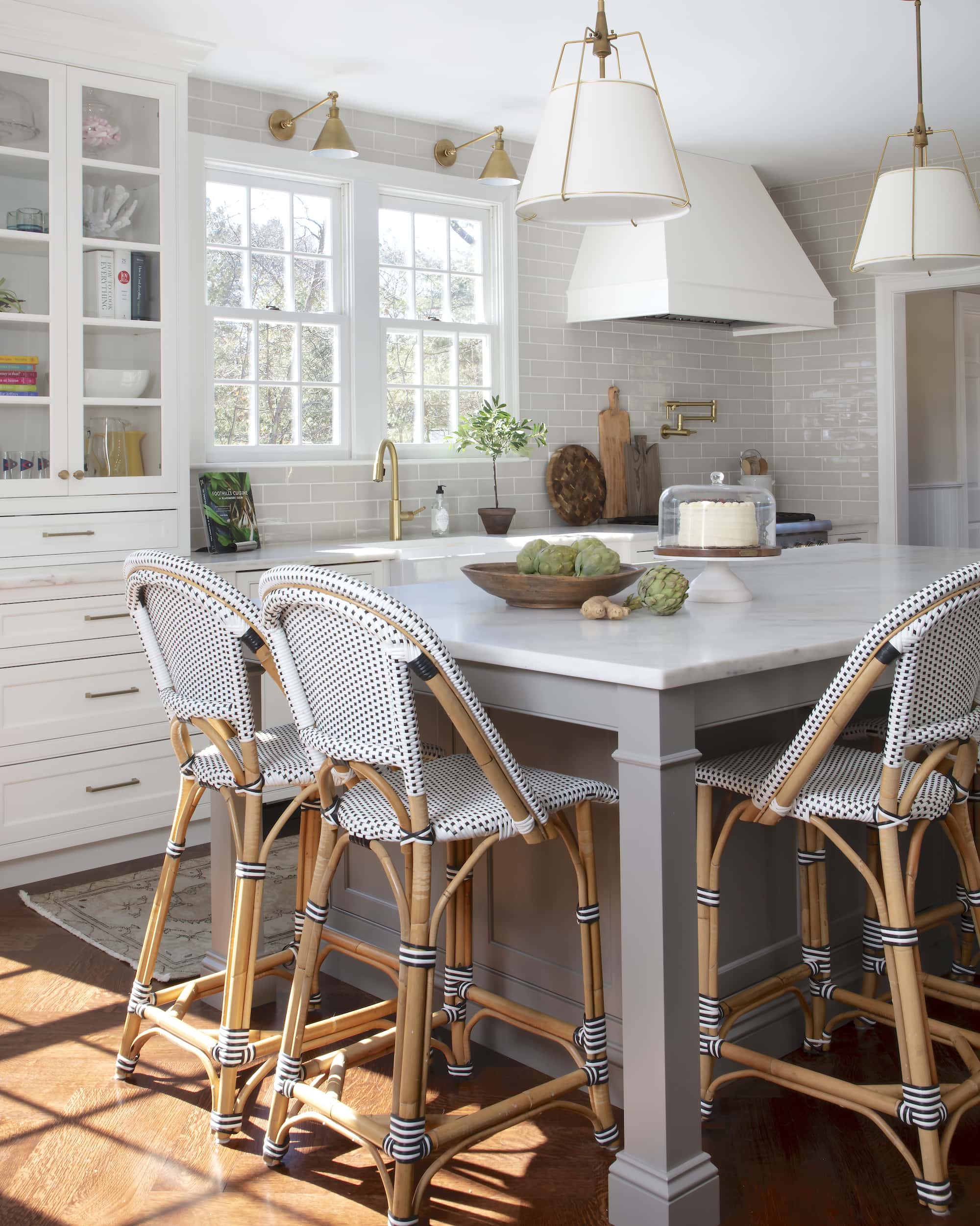 bistro barstools, gray kitchen island, white kitchen cabinets