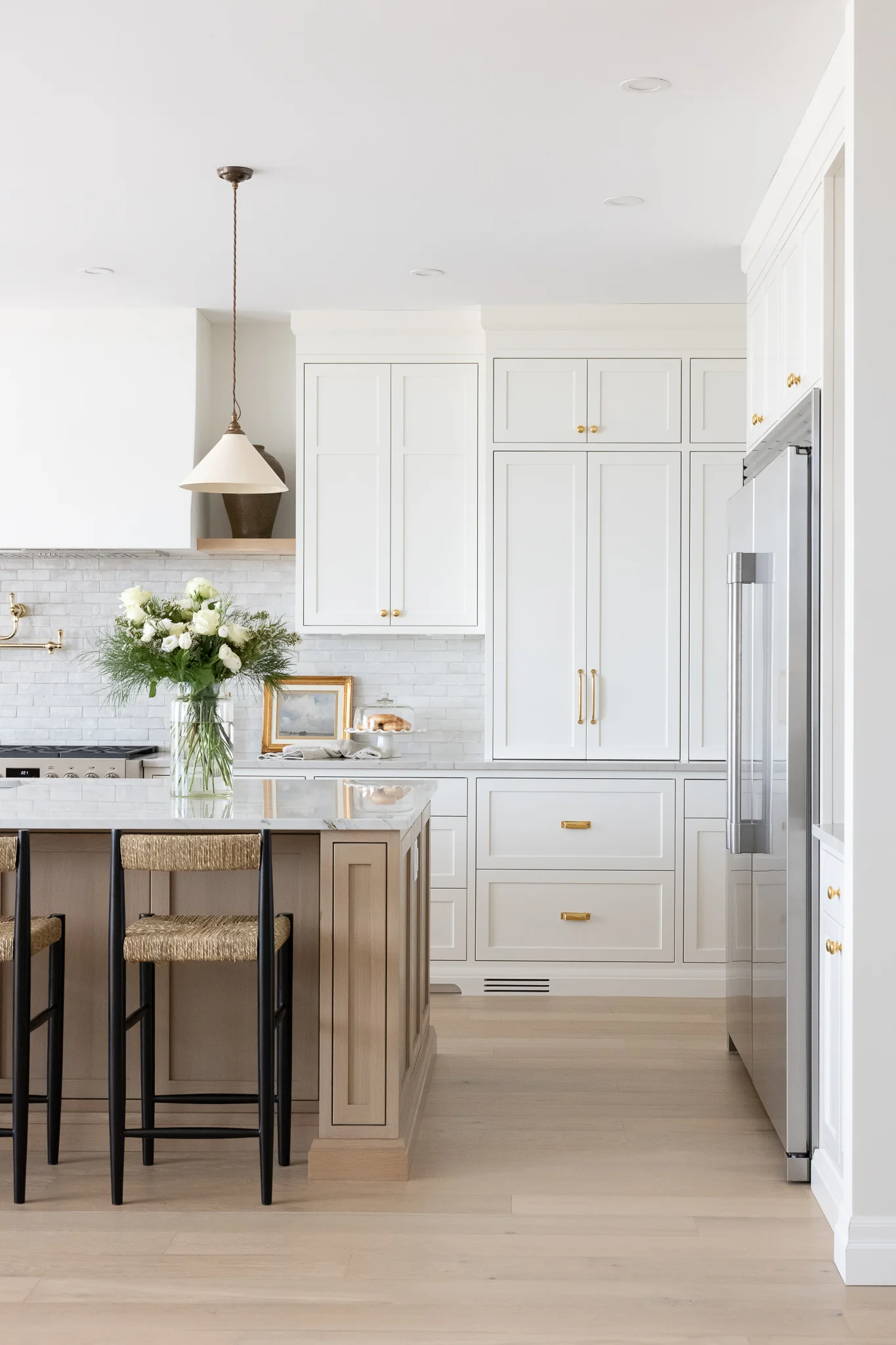 white kitchen with natural wood kitchen island