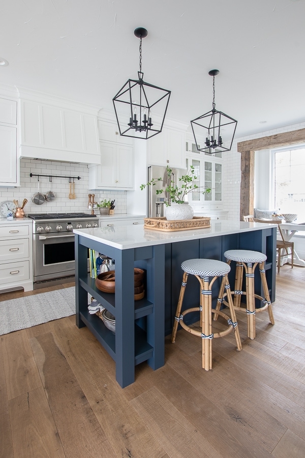 navy kitchen island with white kitchen cabinets