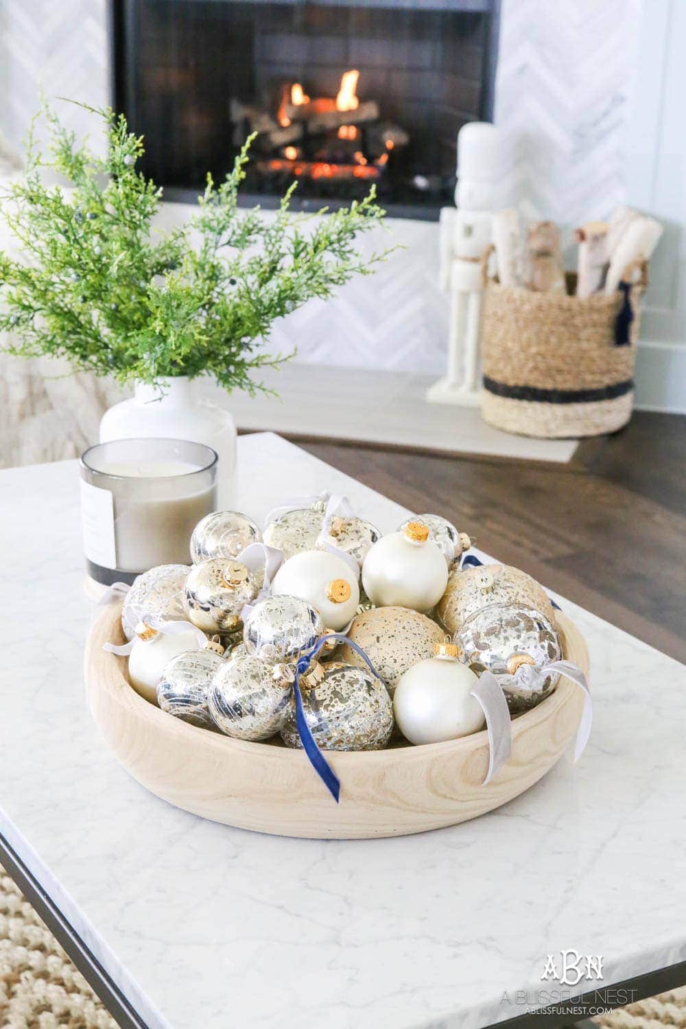 bowl of ornaments with velvet ribbons tied to them.