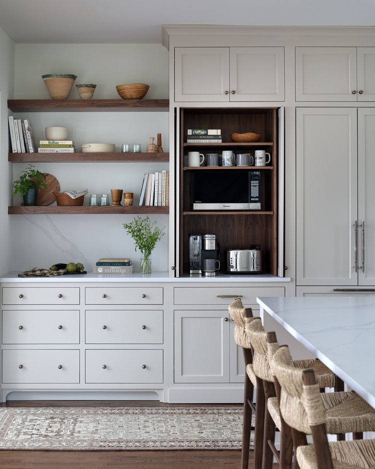 built in coffee bar with coffee mugs, microwave and taster all in 1 cabinet