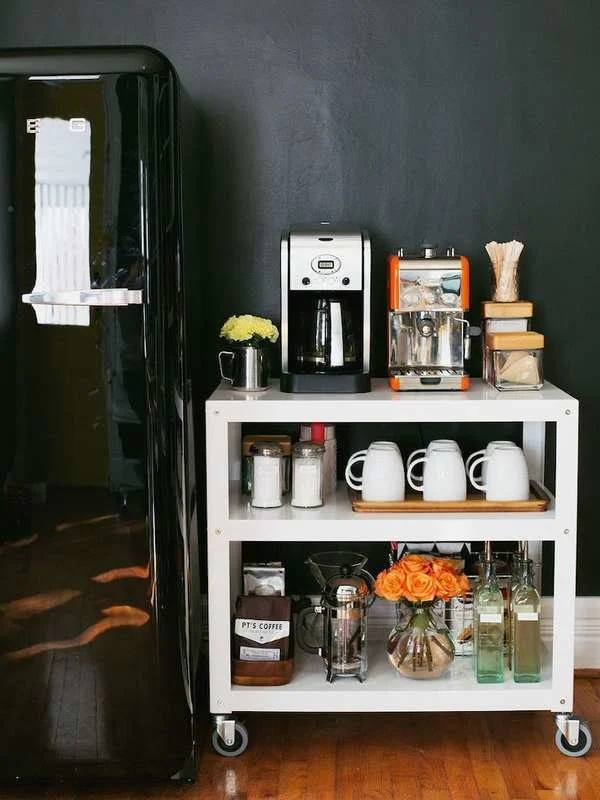 white rolling cart set up as a coffee station in a work place