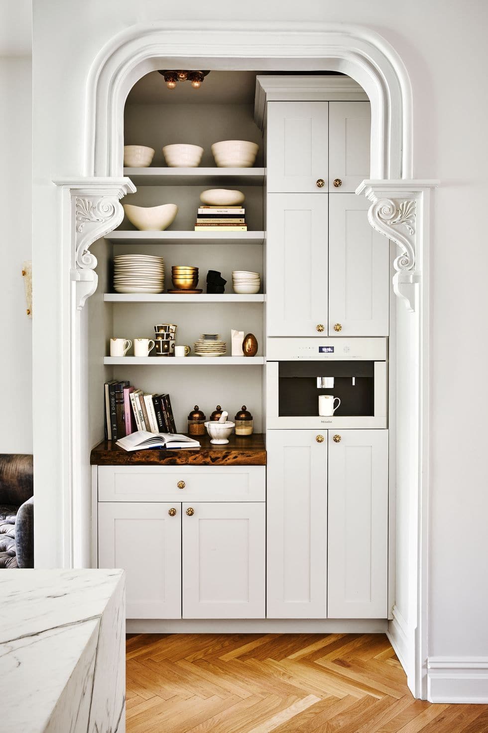 built in coffee machine into cabinettry