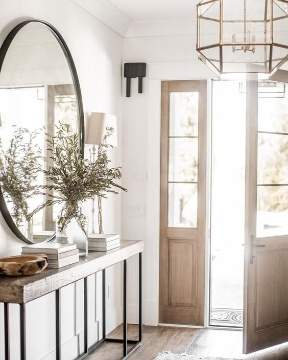 rustic wood table with iron base in an entryway