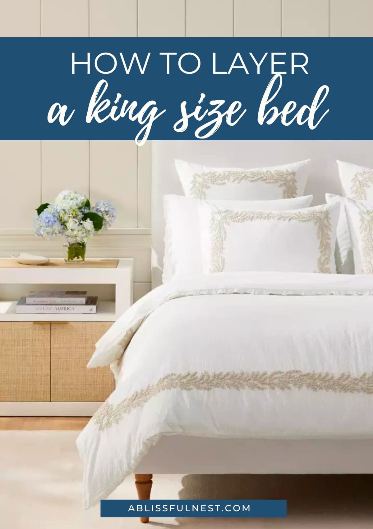 white bedding with a beige embroidered band