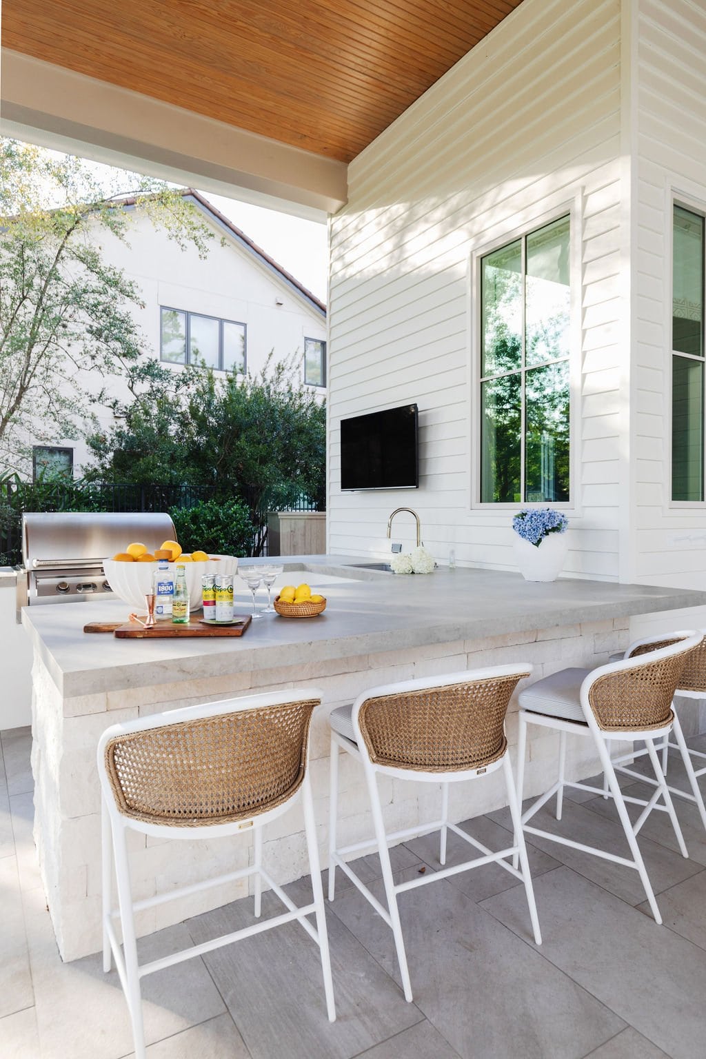 Small outdoor kitchen with a bar area and barstools