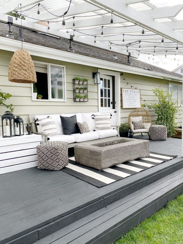 string lights hanging from pergola above a patio